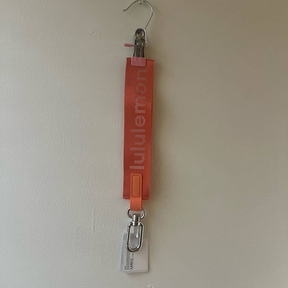 NWT Lululemon Orange Keychain. small stain on keychain